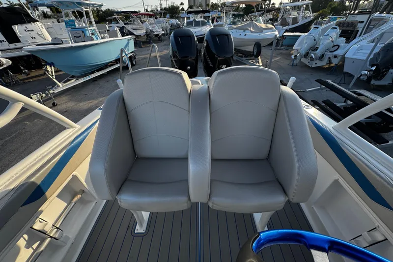 Slide: The Image of 2012 Renegade 32 CC boat with dual seats and visible outboard motors. - 7