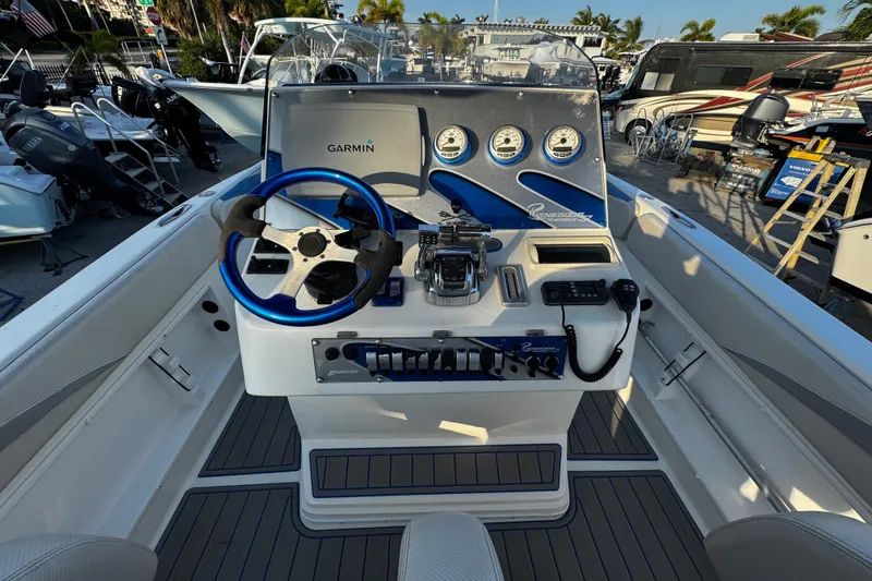 Slide: The Image of Cockpit of 2012 Renegade 32 CC boat with Garmin navigation system and controls. - 8