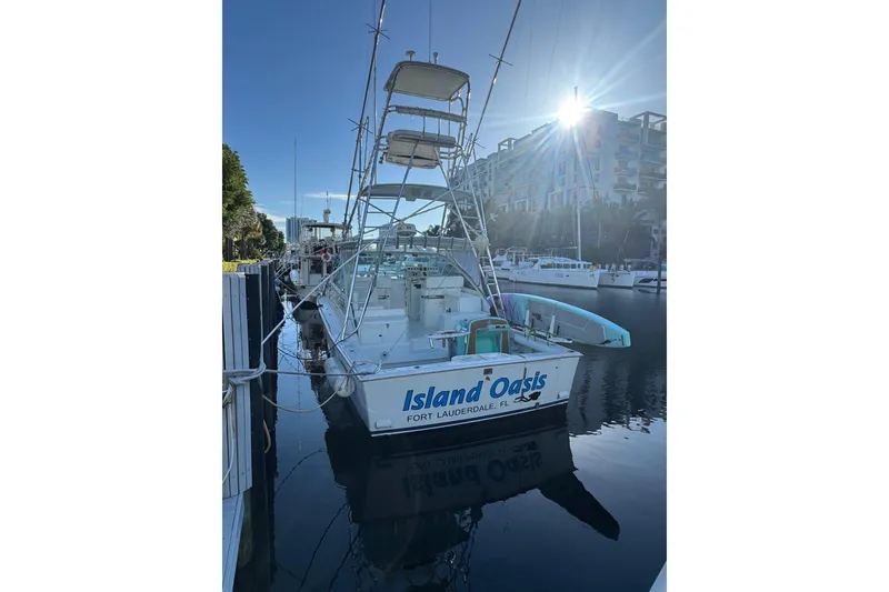 Slide: The Image of 2001 Cabo 35 Express boat docked, named "Island Oasis," in Fort Lauderdale marina. - 3