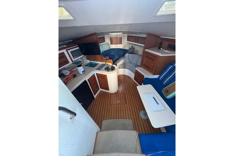 Slide: The Image of Interior of 2001 Cabo 35 Express boat with cozy seating and kitchenette. - 6