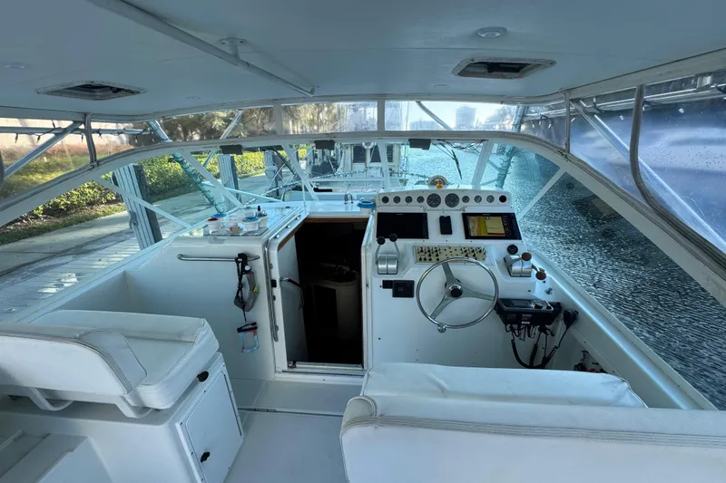 Slide: The Image of Interior view of a 2001 Cabo 35 Express boat, featuring helm and seating area. - 8