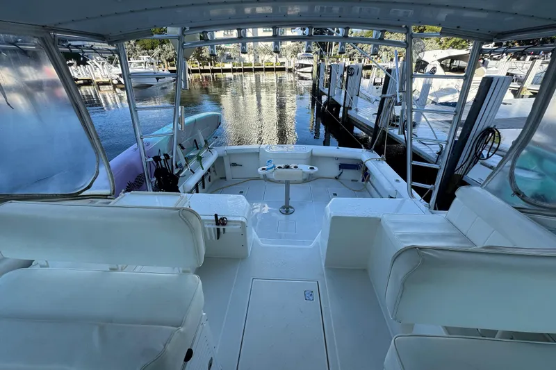 Slide: The Image of 2001 Cabo 35 Express boat interior with white seating, docked at marina. - 9