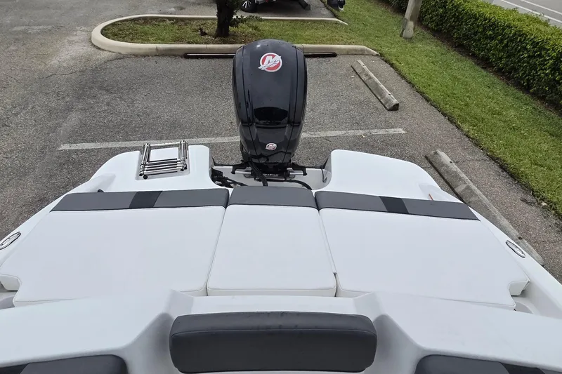 Slide: The Image of 2025 Tahoe T18 boat with outboard motor in parking lot. - 4