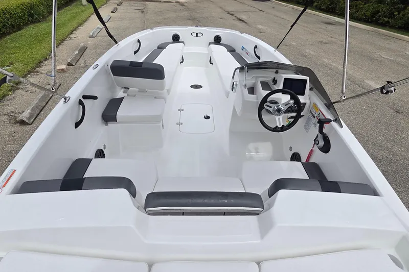 Slide: The Image of 2025 Tahoe T18 boat interior with seating and steering console. - 8