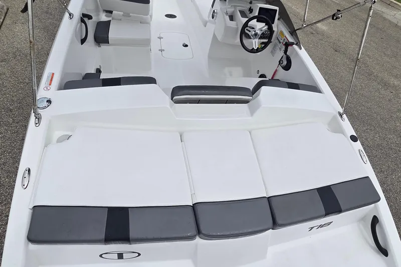 Slide: The Image of 2025 Tahoe T18 boat interior with seating and steering wheel, showcasing modern design. - 9