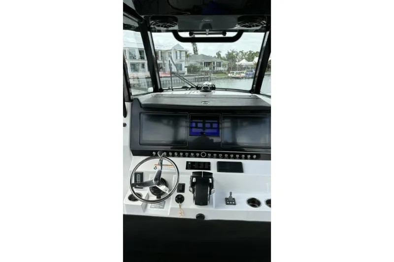 Slide: The Image of 2024 Fountain 32 NX Sportfish helm with modern controls and navigation screens. - 10