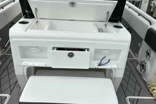 Slide: The Image of 2024 Fountain 32 NX Sportfish boat interior with storage compartments and seating. - 6