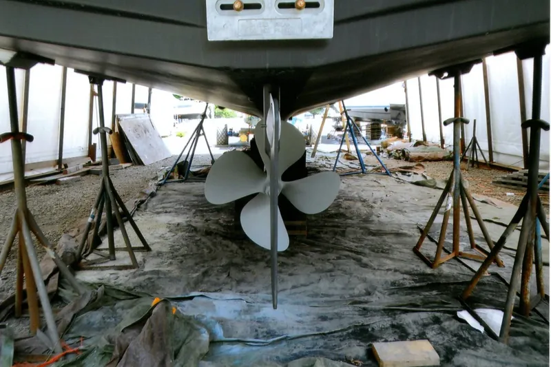Slide: The Image of Underneath view of a 1986 Custom Lynnwood Flybridge Sedan boat on stands. - 103