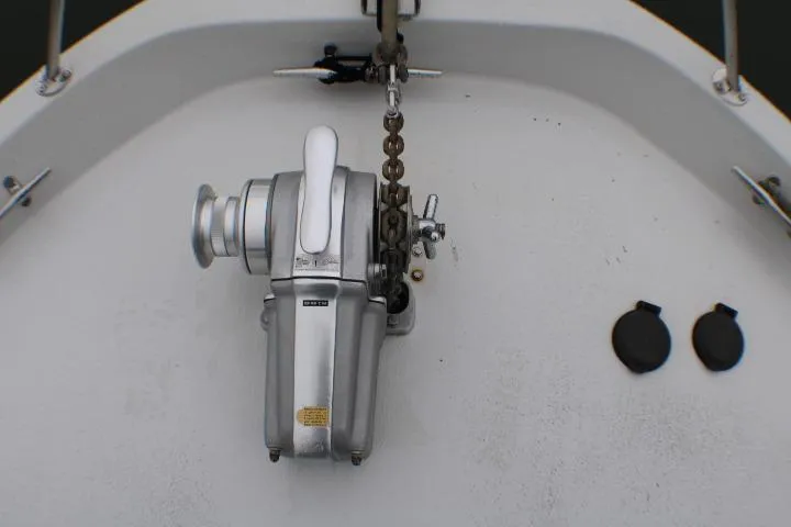 Slide: The Image of 1986 Lynnwood Flybridge Sedan anchor winch on deck with chain and fittings. - 11