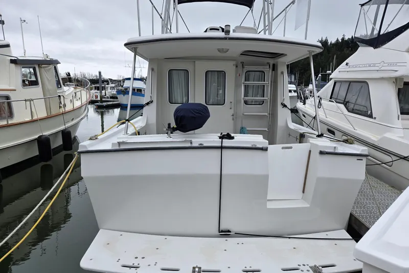 Slide: The Image of 1986 Lynnwood Flybridge Sedan docked at marina, rear view. - 16