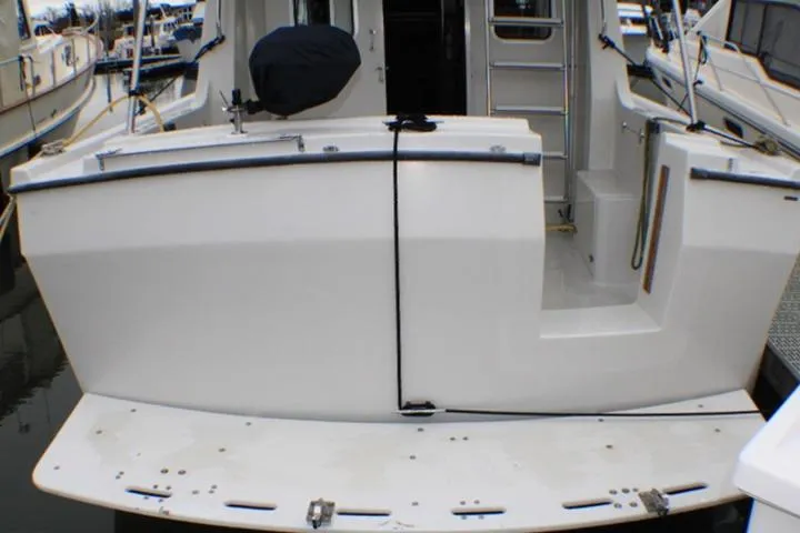 Slide: The Image of 1986 Lynnwood Flybridge Sedan boat stern view at marina. - 17