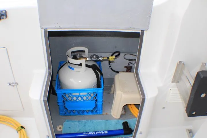 Slide: The Image of Storage compartment on a 1986 Lynnwood Flybridge Sedan with propane tank and accessories. - 24
