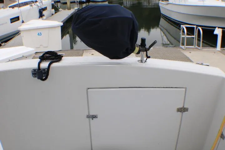 Slide: The Image of 1986 Lynnwood Flybridge Sedan boat stern with covered equipment at marina. - 25