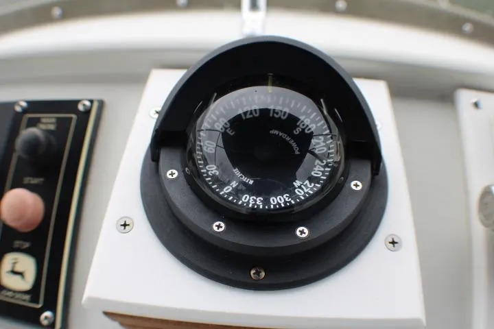 Slide: The Image of Compass on 1986 Lynnwood Flybridge Sedan boat dashboard, close-up view. - 35