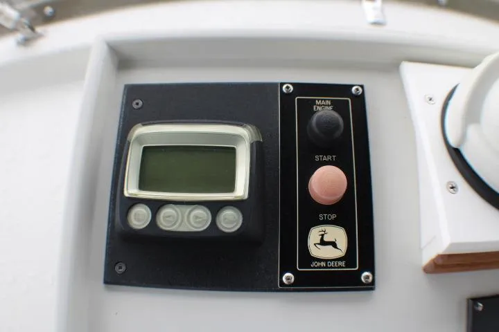 Slide: The Image of Control panel of a 1986 Lynnwood Flybridge Sedan with John Deere engine controls. - 36