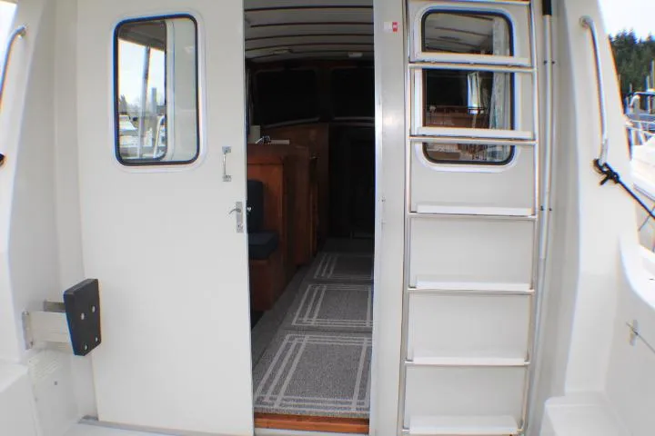 Slide: The Image of 1986 Lynnwood Flybridge Sedan interior view with open doors and ladder. - 40