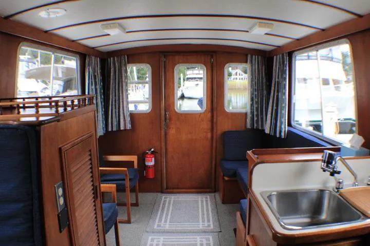 Slide: The Image of Interior of a 1986 Lynnwood Flybridge Sedan boat with wood paneling and seating. - 41