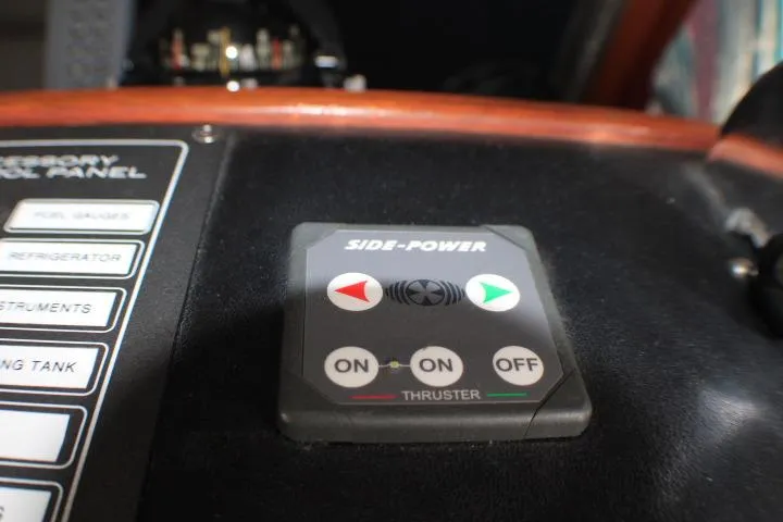 Slide: The Image of Control panel of a 1986 Lynnwood Flybridge Sedan boat with Side-Power thruster controls. - 44