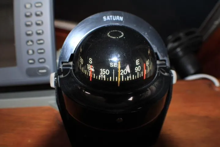 Slide: The Image of Compass on 1986 Lynnwood Flybridge Sedan boat dashboard, displaying cardinal directions. - 45
