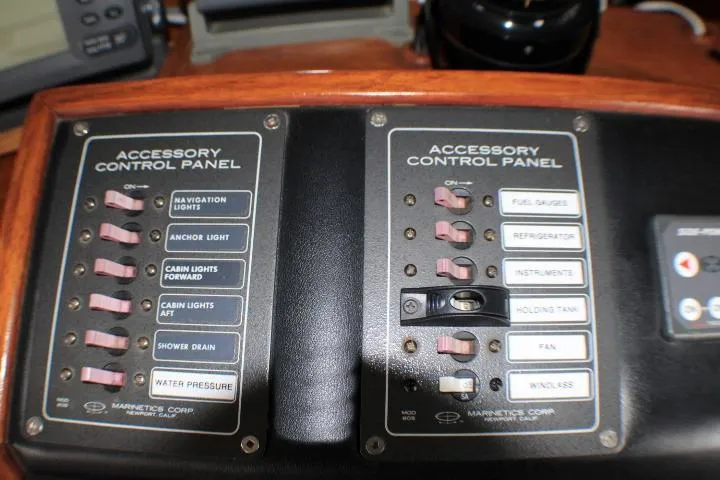 Slide: The Image of 1986 Lynnwood Flybridge Sedan accessory control panel with labeled switches and indicators. - 47
