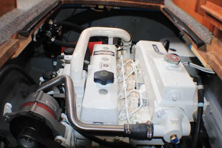 Slide: The Image of Engine compartment of a 1986 Lynnwood Flybridge Sedan boat, showcasing a well-maintained engine. - 55