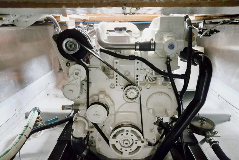 Slide: The Image of Engine compartment of a 1986 Lynnwood Flybridge Sedan boat, showcasing mechanical components. - 58