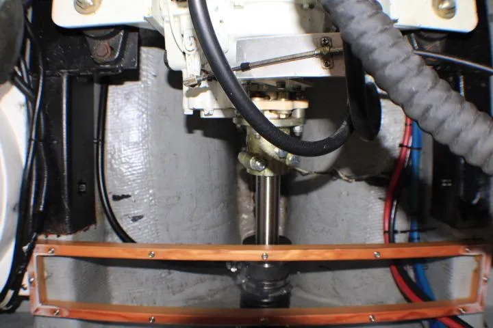 Slide: The Image of Engine compartment of a 1986 Lynnwood Flybridge Sedan boat, showcasing mechanical components. - 61