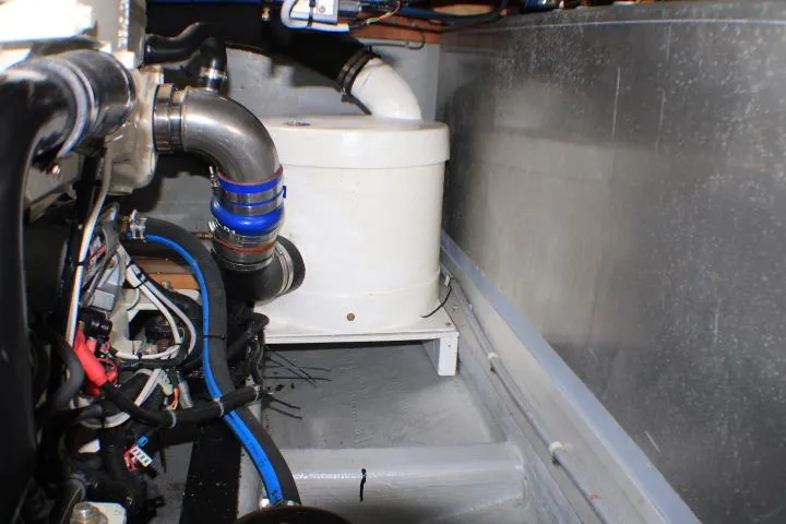 Slide: The Image of Engine room of 1986 Lynnwood Flybridge Sedan with visible pipes and wiring. - 63