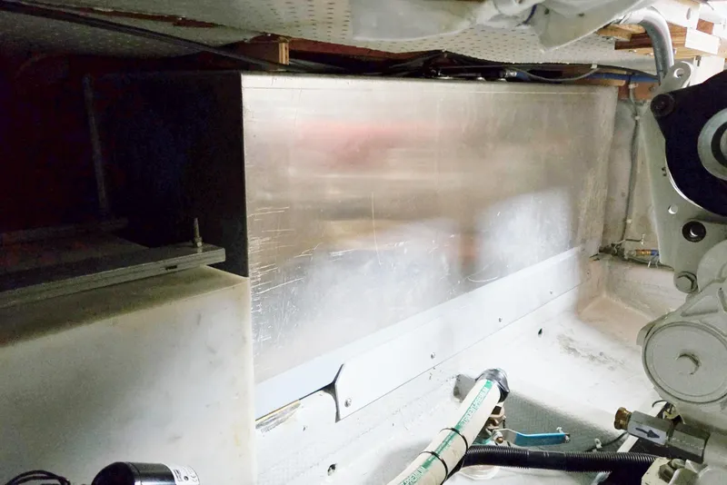 Slide: The Image of Engine compartment of a 1986 Lynnwood Flybridge Sedan boat, showcasing mechanical components. - 66