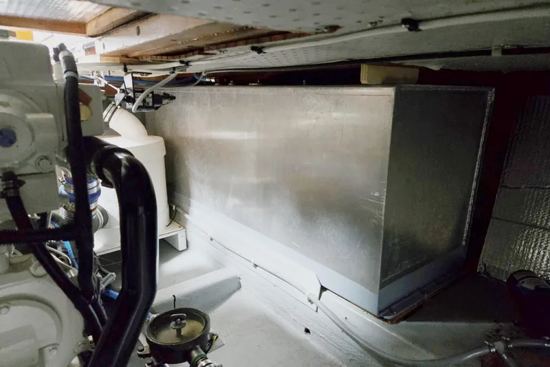 Slide: The Image of Engine room of a 1986 Lynnwood Flybridge Sedan, showcasing machinery and metal components. - 67