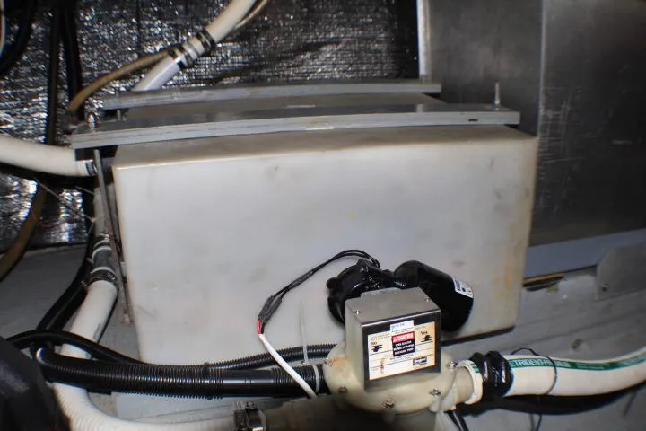 Slide: The Image of 1986 Lynnwood Flybridge Sedan engine compartment with pipes and machinery. - 69