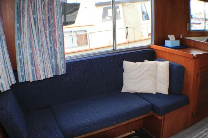 Slide: The Image of Interior of 1986 Lynnwood Flybridge Sedan with blue seating and window view. - 74