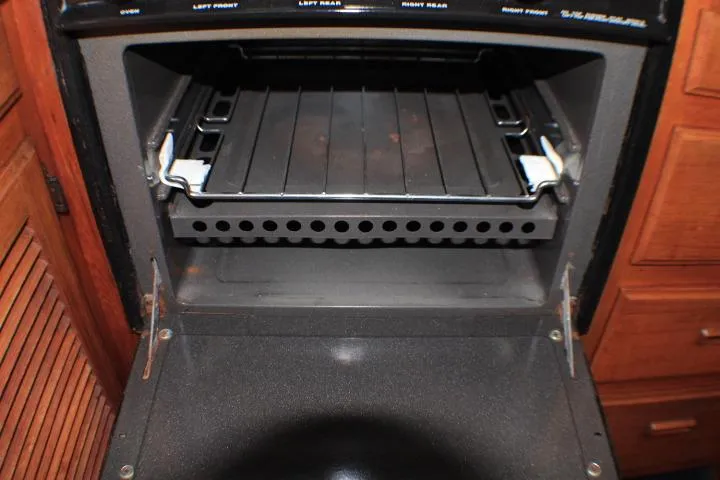 Slide: The Image of Open oven inside a 1986 Lynnwood Flybridge Sedan boat kitchen. - 82