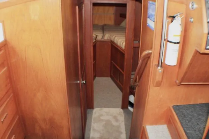 Slide: The Image of Interior of a 1986 Lynnwood Flybridge Sedan boat with wood paneling and cozy cabin. - 85