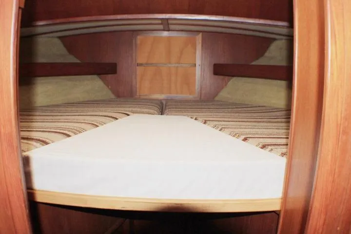 Slide: The Image of Interior cabin of 1986 Lynnwood Flybridge Sedan with wooden finish and striped bedding. - 87