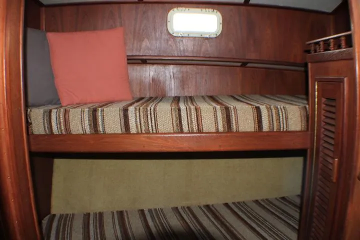 Slide: The Image of Interior of 1986 Lynnwood Flybridge Sedan with striped bunk beds and wooden paneling. - 93