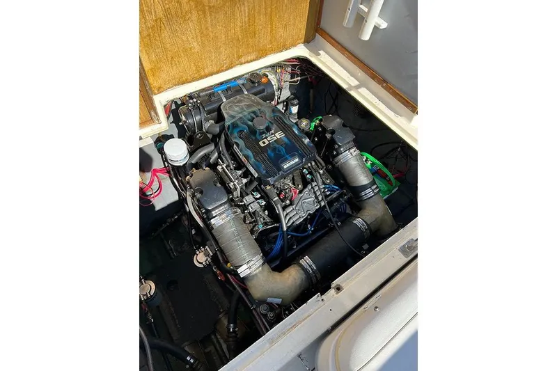 Slide: The Image of Engine compartment of a 1973 Bertram 28 Flybridge Cruiser, showcasing a modern engine setup. - 10