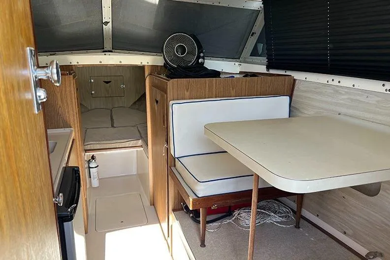 Slide: The Image of Interior of a 1973 Bertram 28 Flybridge Cruiser with seating and table. - 11