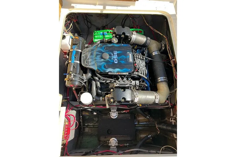 Slide: The Image of Engine compartment of a 1973 Bertram 28 Flybridge Cruiser, showcasing detailed wiring and components. - 12