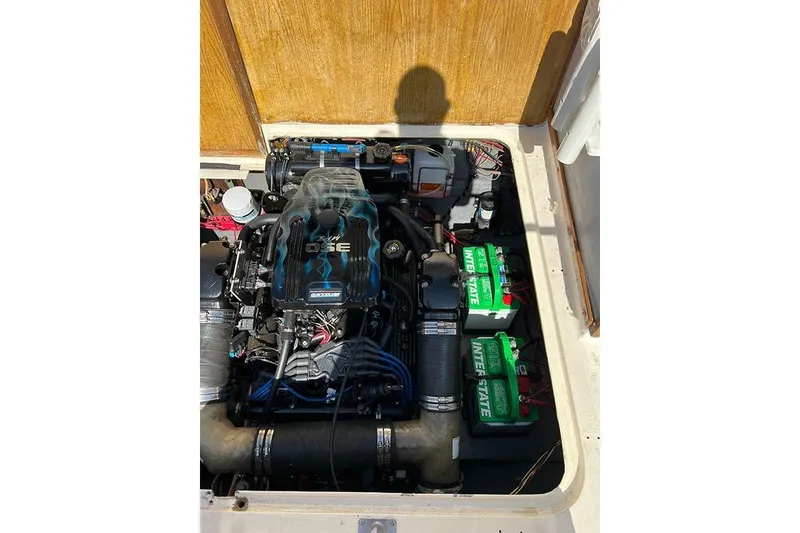 Slide: The Image of Engine compartment of a 1973 Bertram 28 Flybridge Cruiser with visible batteries and components. - 13