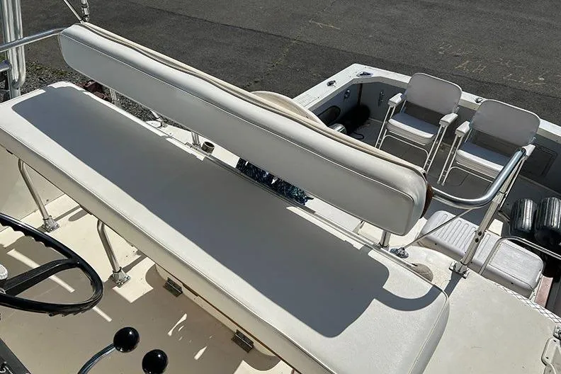Slide: The Image of 1973 Bertram 28 Flybridge Cruiser interior with white seating and steering wheel. - 8