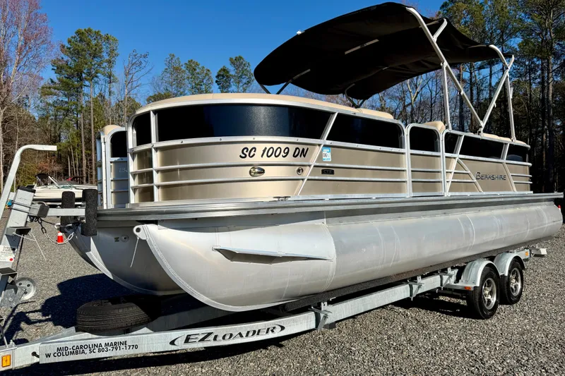 The Image of 2020 Berkshire 25SL pontoon boat on trailer, parked outdoors. - 1