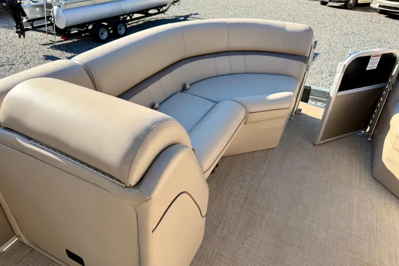 Slide: The Image of 2020 Berkshire 25SL pontoon boat interior with beige seating and open gate. - 10