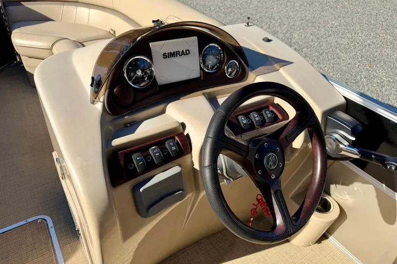 Slide: The Image of Steering console of a 2020 Berkshire 25SL boat with Simrad display and controls. - 11
