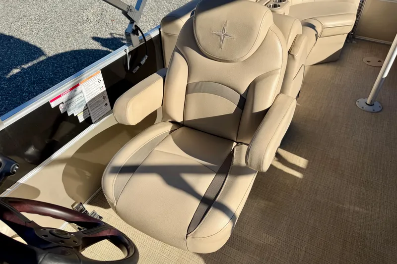 Slide: The Image of 2020 Berkshire 25SL boat interior with beige captain's chair and steering wheel. - 13