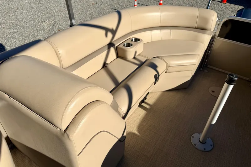 Slide: The Image of 2020 Berkshire 25SL boat interior with beige seating and cup holders. - 14