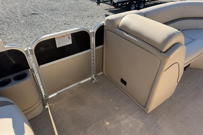 Slide: The Image of Interior of a 2020 Berkshire 25SL pontoon boat with beige seating and cup holders. - 18