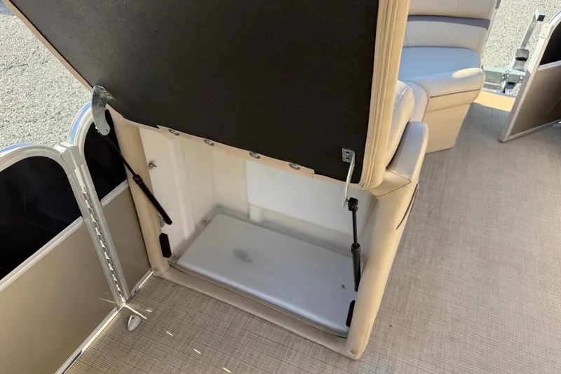 Slide: The Image of Open storage compartment in 2020 Berkshire 25SL boat with beige interior. - 19