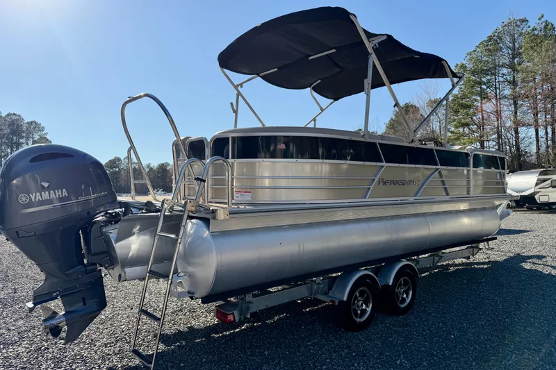 Slide: The Image of 2020 Berkshire 25SL pontoon boat with Yamaha motor, parked on a trailer. - 2