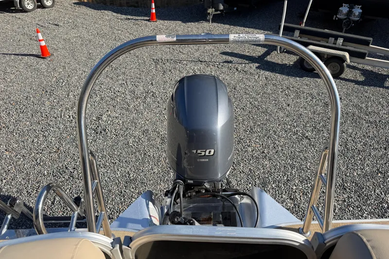 Slide: The Image of 2020 Berkshire 25SL boat with Yamaha 150 outboard motor on gravel surface. - 20